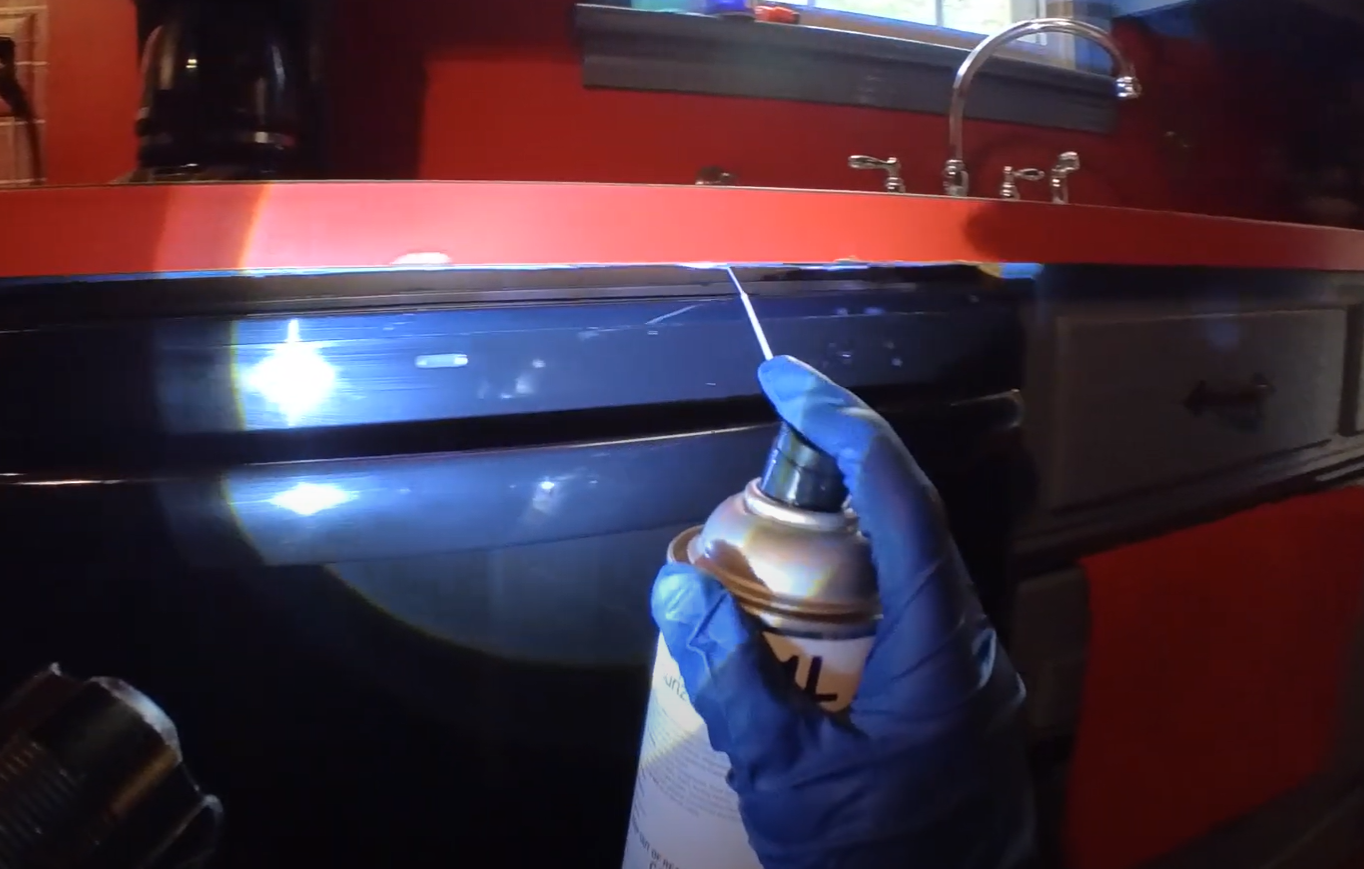 A technician using spray treatment along a kitchen counter to prevent pests, showing Pest Control Service in Cicero in action.